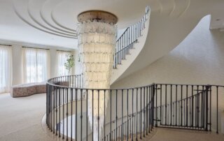 Foglio Inverno chandelier by Rocco Borghese – cascading Murano glass leaves layered over crystal, bespoke stairwell chandelier